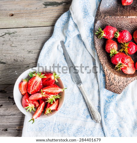 fresh red strawberry slices in a white piala, rustic background,  clean eating,top view