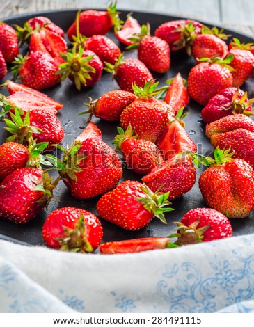 fresh juicy strawberries on a black tray, top view, clean eating