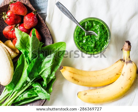 Green smoothie with spinach, kiwi, banana and mint in a glass, detox drink, summer, top view