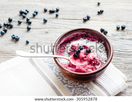 banana ice cream with blueberries and coconut flakes, healthy dessert, vegan breakfast, rustic background