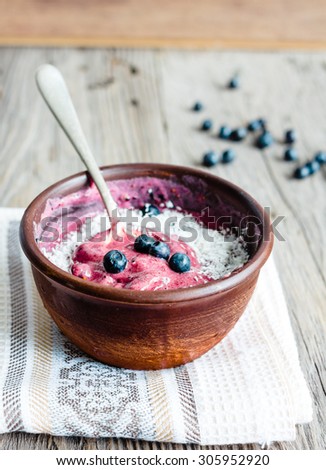 banana ice cream with blueberries and coconut teaspoon, healthy dessert, vegan, selective focus