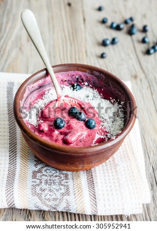 banana ice cream with blueberries and coconut teaspoon, healthy dessert, vegan, selective focus
