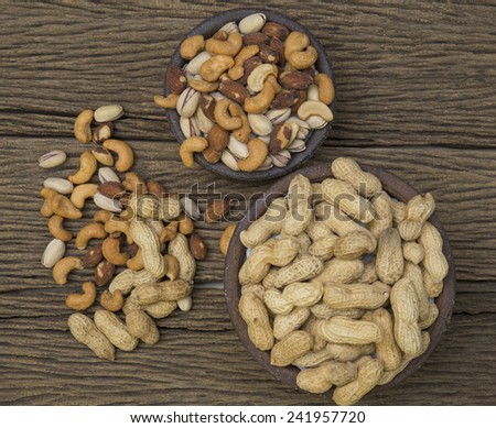 Pigeon peas mixed nuts such as pistachios, peanuts, cashews and almond on a wooden table.