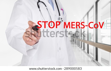 Doctor writing Stop Mers-Cov text on transparent board at new empty hospital hallway background