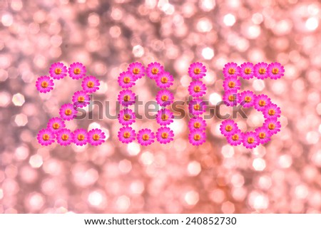 New Year 2015 flower text with Defocused light blur bokeh background