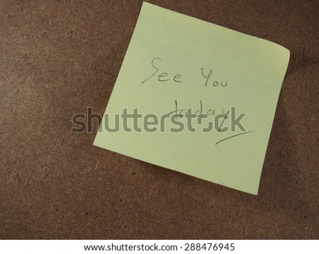 See you today, writing on yellow sticker paper, announced brown board background