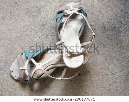 Pair of high heeled, be worn out for lady shoes, scratched leather, weaved pattern on cement background