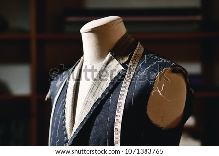 Close up of a suit hanging on hanging clothes, just made to measure by a tailor in his tailoring 商業照片 © 