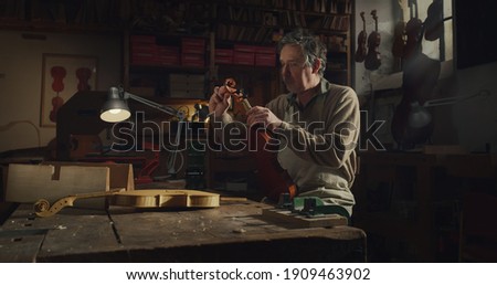 Similar – Image, Stock Photo Craftsman with violin in professional workshop