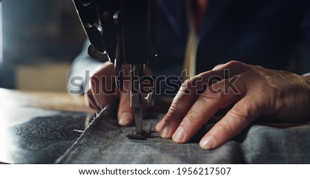 Macro shot of experienced tailor is sewing custom handmade high quality apparel in ancient luxury traditional tailoring workshop. Concept of industry, handmade, hand craft, couturier and tradition. Foto stock © 