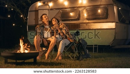 Similar – Image, Stock Photo Female traveler with blanket standing on lake shore against mountains