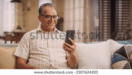 Similar – Image, Stock Photo Senior man using mobile phone on table near laptop