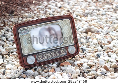 Vintage frame for the photo in the form of old radio on a stones background. The foreign text \