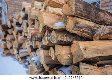 Stacked firewood outside the house, the winter season, focus on foreground