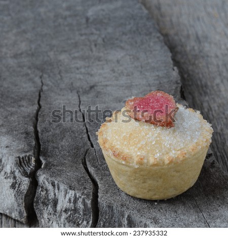 Black Berry Pie Cupcake with Heart and Sugar Topping on Wooden Background