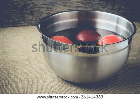 apples in a pail of water on retro background with Instagram Style Filter