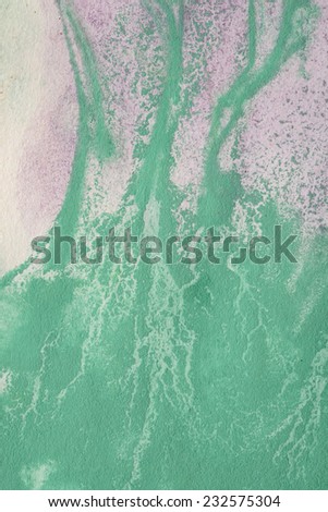 abstract green paint with the color purple dried up wet stains