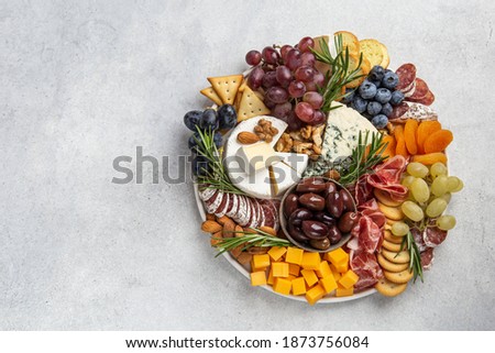Appetizers boards with assorted cheese, meat, grape and nuts. Charcuterie and cheese platter. Top view, copy space Stockfoto © 