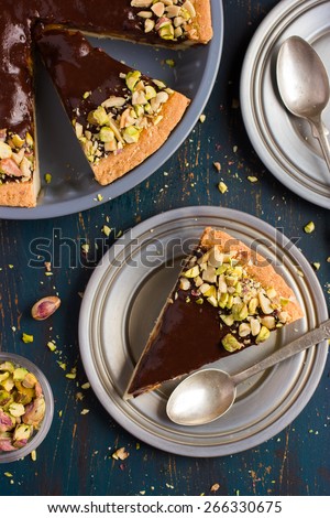 Tart with caramel, chocolate and nuts, top view
