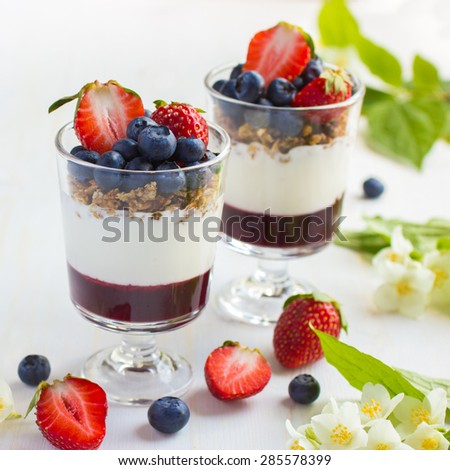 dessert with fresh berries,  cream cheese, granola and berries  jam, square image