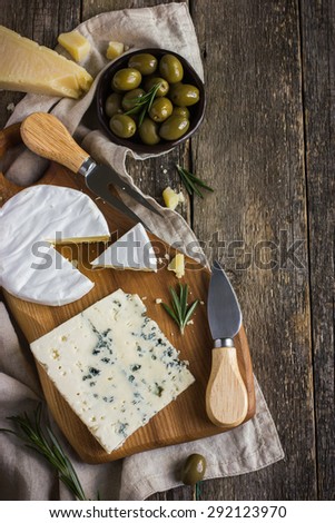 camembert and blue cheese  on wooden cutting board, top view