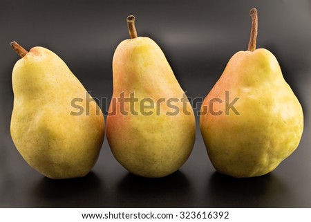 Three pears isolated on the black.
