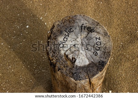 Sawn and planted wooden pole in the sand in the protected area beach. Inscription: Plastic free zone. Coastal Botanical Garden of Porto Caleri, Po delta, Italy. Zdjęcia stock © 
