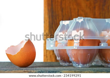 The shell of the egg and the plastic tray