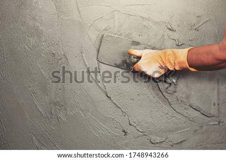 hand of worker plastering cement at wall for building house Photo stock © 