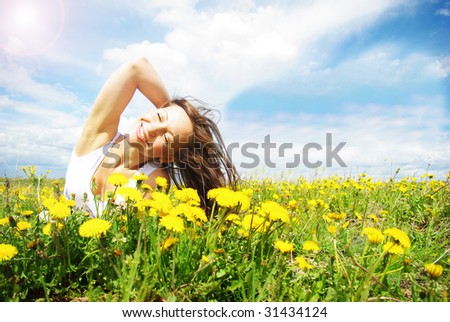 girl lying in a meadow enjoying the sun