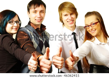 Four young people on white background laughing and giving the thumbs-up sign.