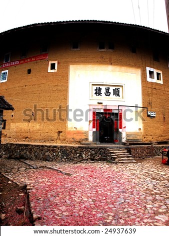 The Earth Tower of Hakka  -an ancient Chinese building in Hujian, China which was in the list ofthe  world heritage. In Chinese spring festival, villagers burn firecracker before the earth tower.