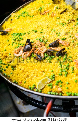 Street food paella at the market, with sea food