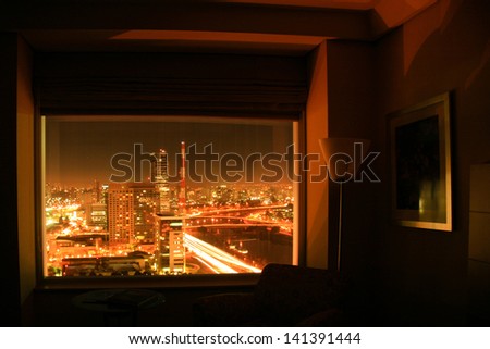 View of Sao Paulo city in Brazil seen from inside a hotel room at night.
