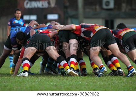 KUALA LUMPUR - MARCH 29: Rugby players scrum during the NICC final rugby match between SSTMI Bandar Penawar and RSC Dog on March 29,2012 in Kuala Lumpur, Malaysia. SSTMI won 24-15.