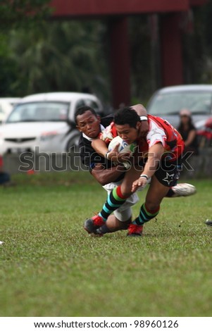 KUALA LUMPUR-MARCH 31:Unidentified Bandaraya Dragons player tackle Keris Conlay player during a Malaysian Rugby Union(MRU) Super League match on March 31,2012 in Kuala Lumpur,Malaysia.Conlay won 21-15