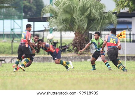 KUALA LUMPUR-APRIL 8: Players compete for the ball possession a MRU Super League match between Keris Conlay(green jersey) and ATM RAMD  on April 8, 2012 in Kuala Lumpur, Malaysia. Conlay won 29-12
