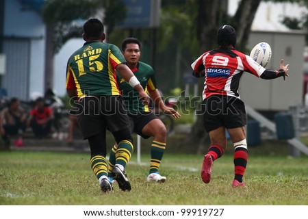 KUALA LUMPUR - APRIL 1:Unidentified ASAS player passes the ball during a Malaysian Rugby Union(MRU) Super League match against ATM RAMD on April 1, 2012 in Kuala Lumpur, Malaysia. ASAS won 27-25