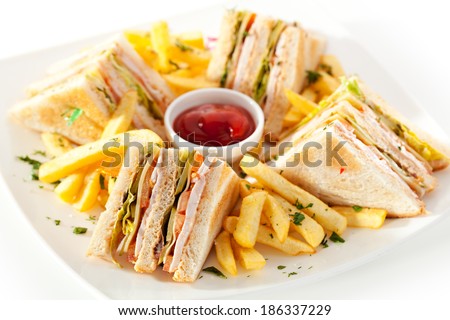 Club Sandwich with Cheese, PIckled Cucmber, Tomato and Smoked Meat. Garnished with French Fries