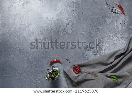 Empty gray stone background with textile and ingredients. Food background in rustic style. Cement table with kitchen towel and spices. Aesthetic minimal background Foto stock © 