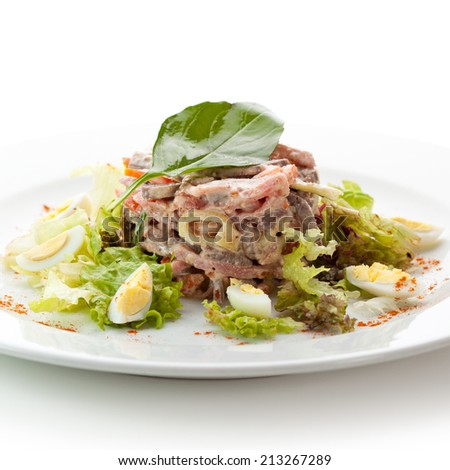 Beef Tongue Salad with Ham, Eggs, Vegetables and Nuts. Garnished with Basil Leaf