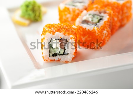 Maki Sushi with Fresh Salmon, Cucumber and Cream Cheese inside. Tobiko outside