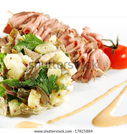 Roast Beef Served with Salad (Potatoes and Vegetables) and Cherry Tomato. Isolated on White Background
