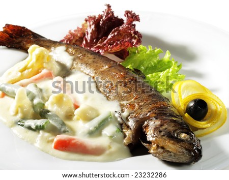 Fish Plate Served with Vegetables Sauce and Salad Leaves. Isolated on White Background