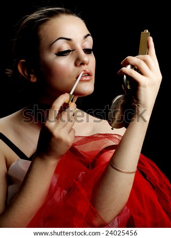 Fashion Model with Lip Gloss and Hand Mirror