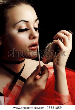 Fashion Model with Lip Gloss and Hand Mirror
