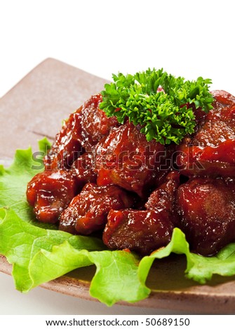 Japanese Cuisine - Beef with Sweet Pepper Deep Fried in  Sour-Sweet Sauce. Garnished on Salad Leaf, Topped with Parsley