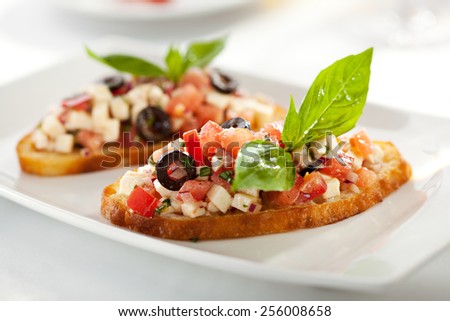 Italian Appetizer Bruschetta with Tomatoes, Cheese and Basil