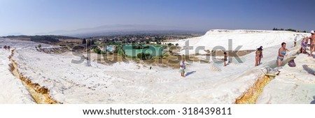 Denizli, Turkey - September 7: Tourists on Pamukkale travertines on September 7 in Pamukkale, Turkey. Pamukkale, UNESCO world heritage site is one of the most visited travel destinations in Turkey.