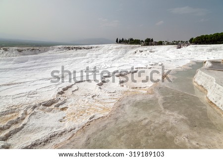 Denizli, Turkey - Sept 7, 2015: Tourists on Pamukkale travertines on September 7 in Pamukkale, Turkey.Pamukkale, UNESCO world heritage site is one of the most visited travel destinations in Turkey.
